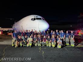 Snyder and BNIA Firefighters in front of Ginger after a night of Hands-On Training